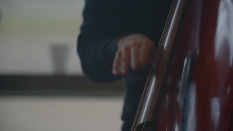 a man is pulling the strings on a musical instrument