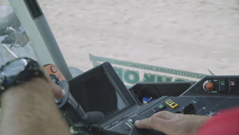 male hands driver on steering wheel tractor. tractor driving