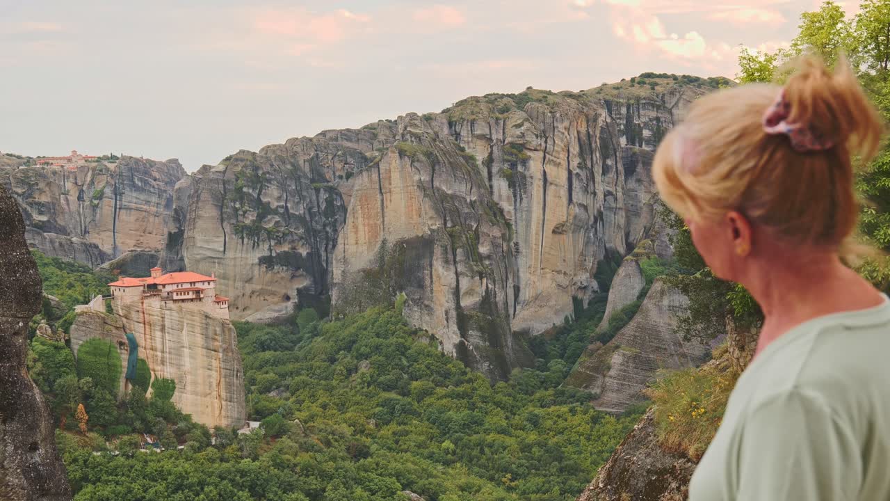 Female tourist gazes upon Greek monastery of St Nicholas Meteora