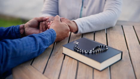 couple, holding hands and praying together