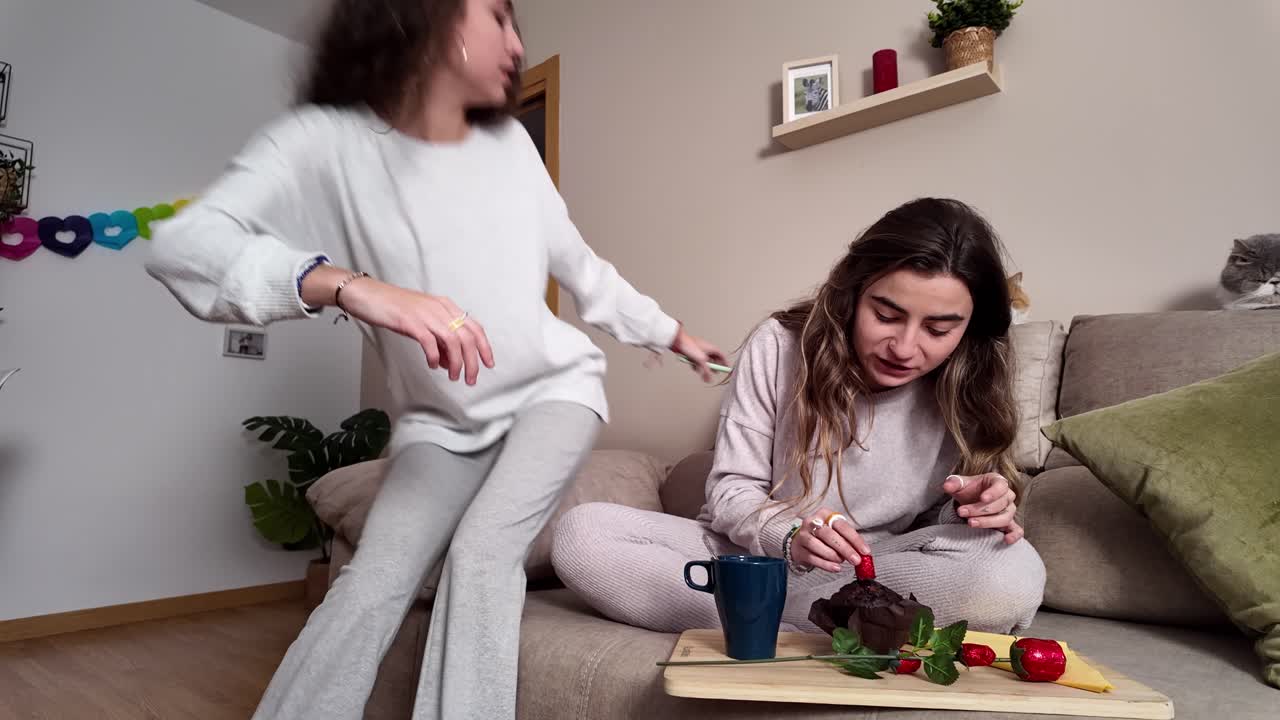 Two women spending time at home with their cats