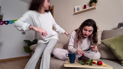 two women spending time at home with their cats