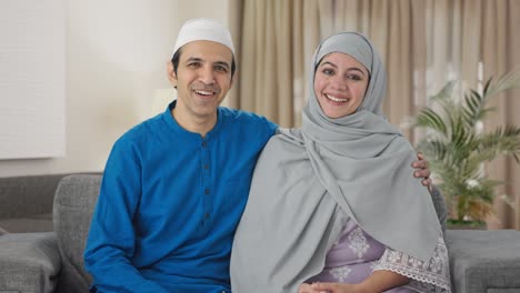 happy muslim couple talking to someone