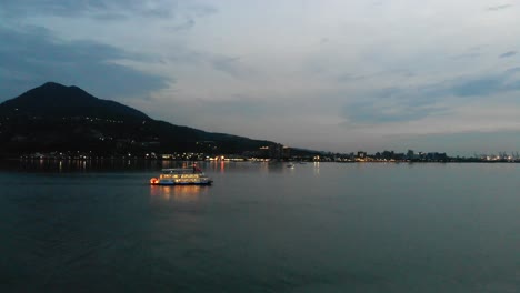 Smooth-aerial-of-boats-in-river-at-dusk