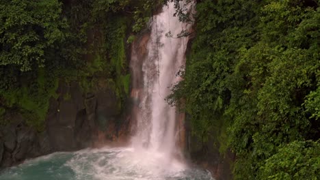 iconic río celeste waterfall, a powerful cascade that plunges into a stunning turquoise-blue pool