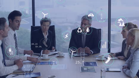 animation of multiple icons over diverse coworkers sharing ideas in meeting at office