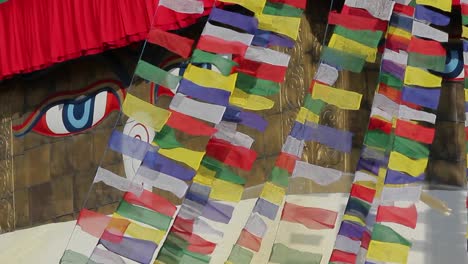 prayer flags streaming  in front of adi buddha