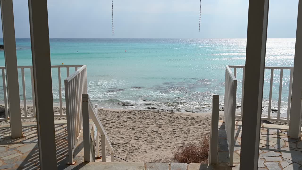 View of turquoise Mediterranean waters from a beachfront walkway in Limassol, Cyprus