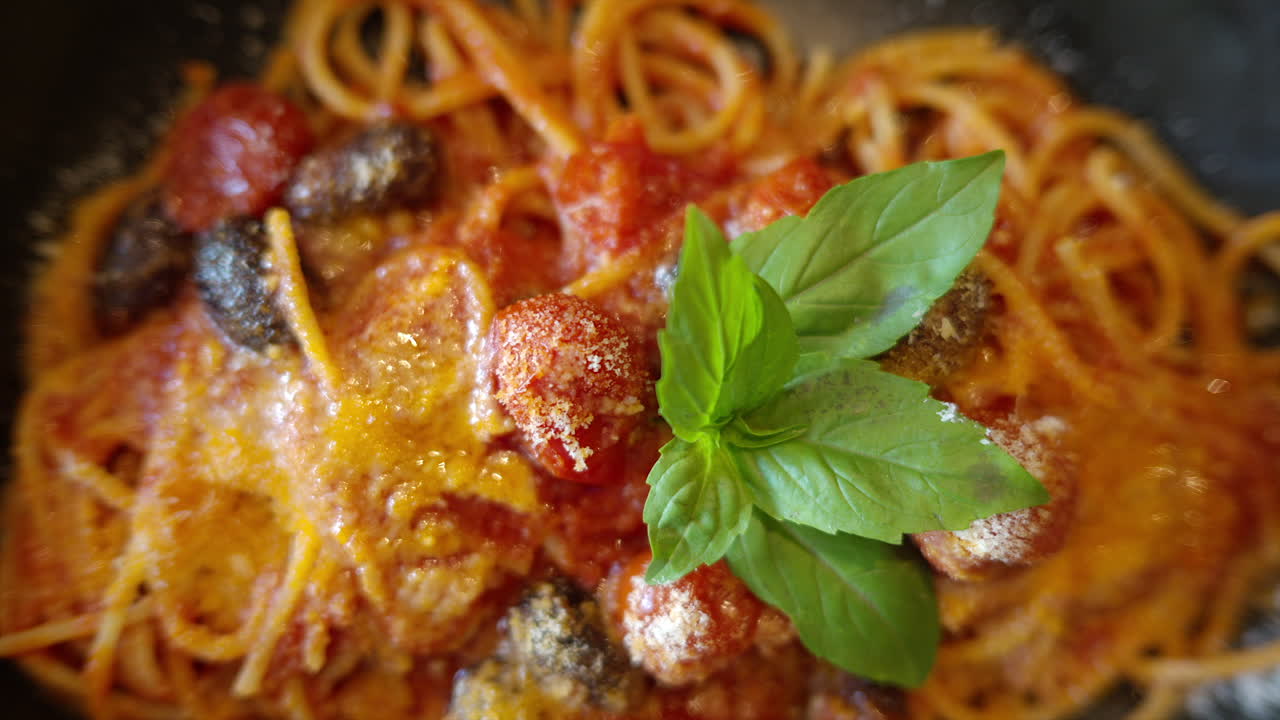 Italian spaghetti with tomatoe and basilic in a restaurant close up