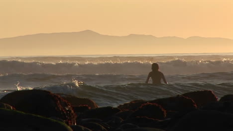 A-surfer-wades-into-the-ocean-1