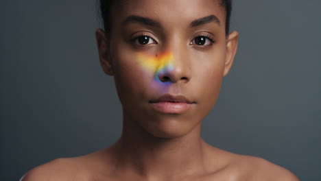 multicolor portrait beautiful african american woman with colorful light reflecting on smooth healthy skin attractive female skincare concept on grey background