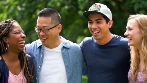 a heartwarming moment of laughter and friendship: four individuals sharing joyful connections in a lush green outdoor setting