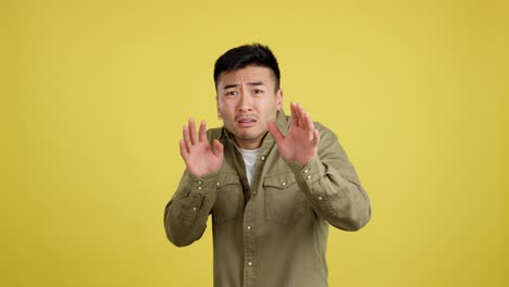 man showing disgust and aversion with his hands and facial expression