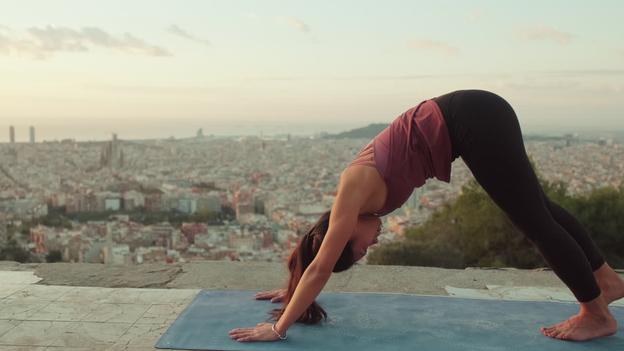 Woman Doing Yoga Pose Overlooking City Skyline