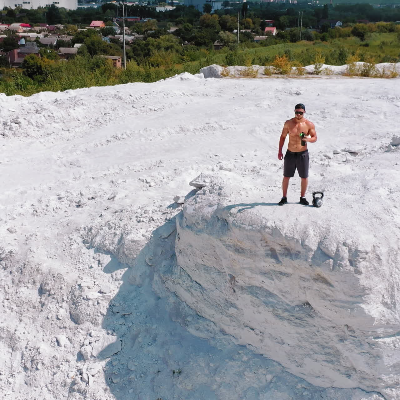 Man working out with kettlebell in a quarry