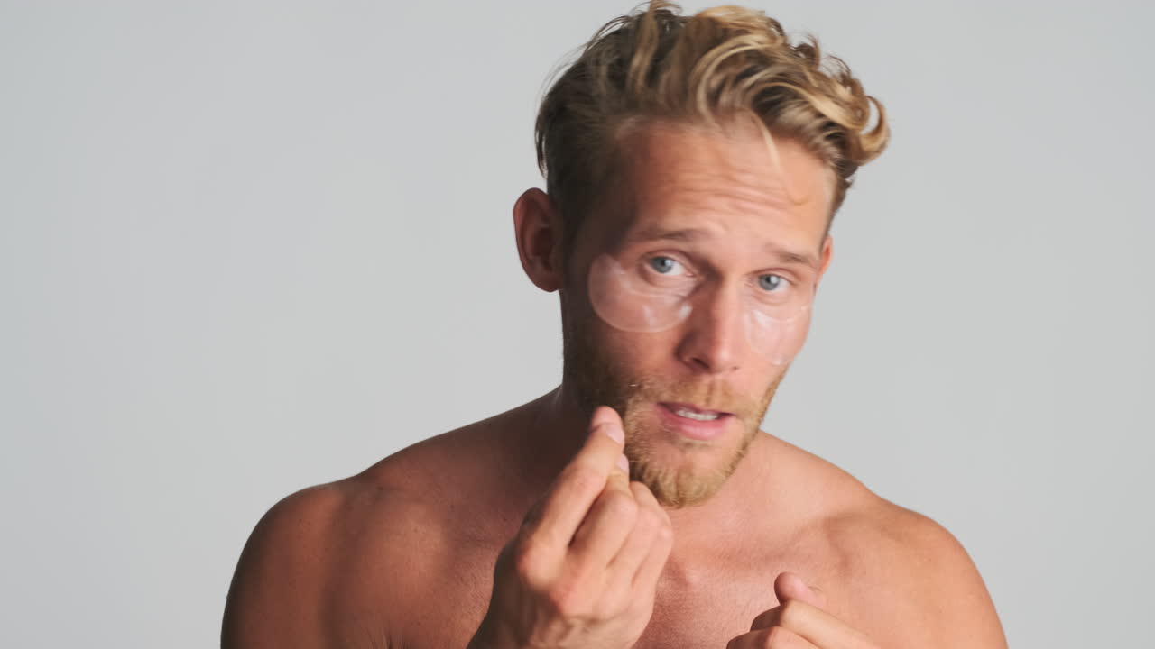 Shirtless happy guy with eye patches