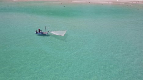 Aerial-shot-of-a-traditional-shrimp-fisherman-on-small-wooden-boat-in-Thailand