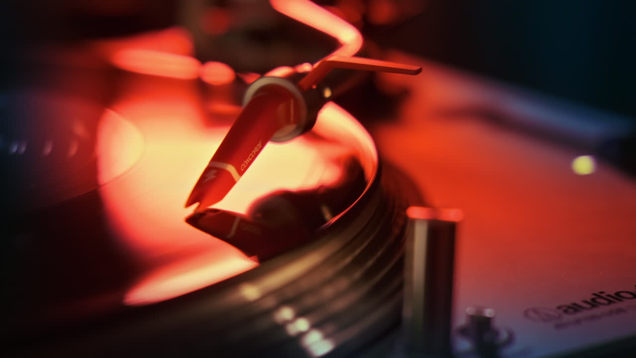 A working record player with a rotating vinyl record. Neon red illumination around