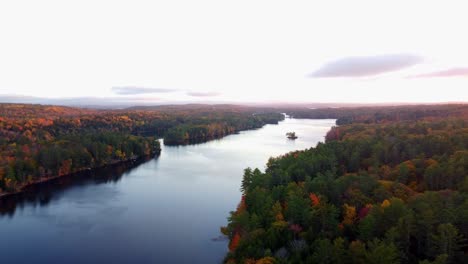 pan over the water of a pond in maine during the fall season