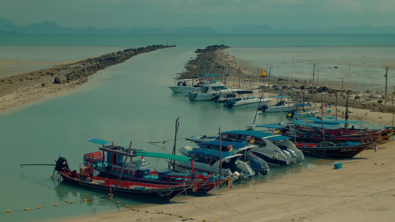 Boats moored at a tropical beach