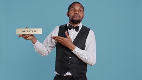 Hotel-concierge-staff-showing-the-reception-indicator-at-front-desk