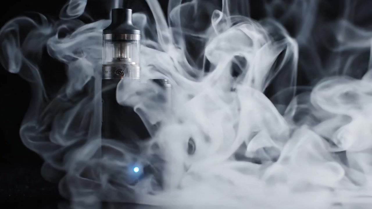 Kiehtova vilahdus modernista vape-laitteesta, joka päästää höyrypilviä, vangiten täydellisesti nykyaikaisen höyryttelykulttuurin olemuksen tummassa tunnelmassa