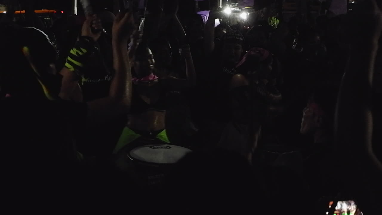 Female drummers rile up crowd at night protest march on Women's Day