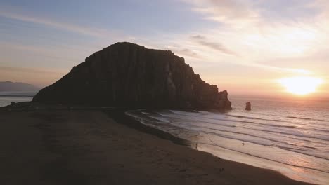 morro bay - california, usa. cinematic aerial sunset dolly forwards along coastline. filmed on dji mavic pro