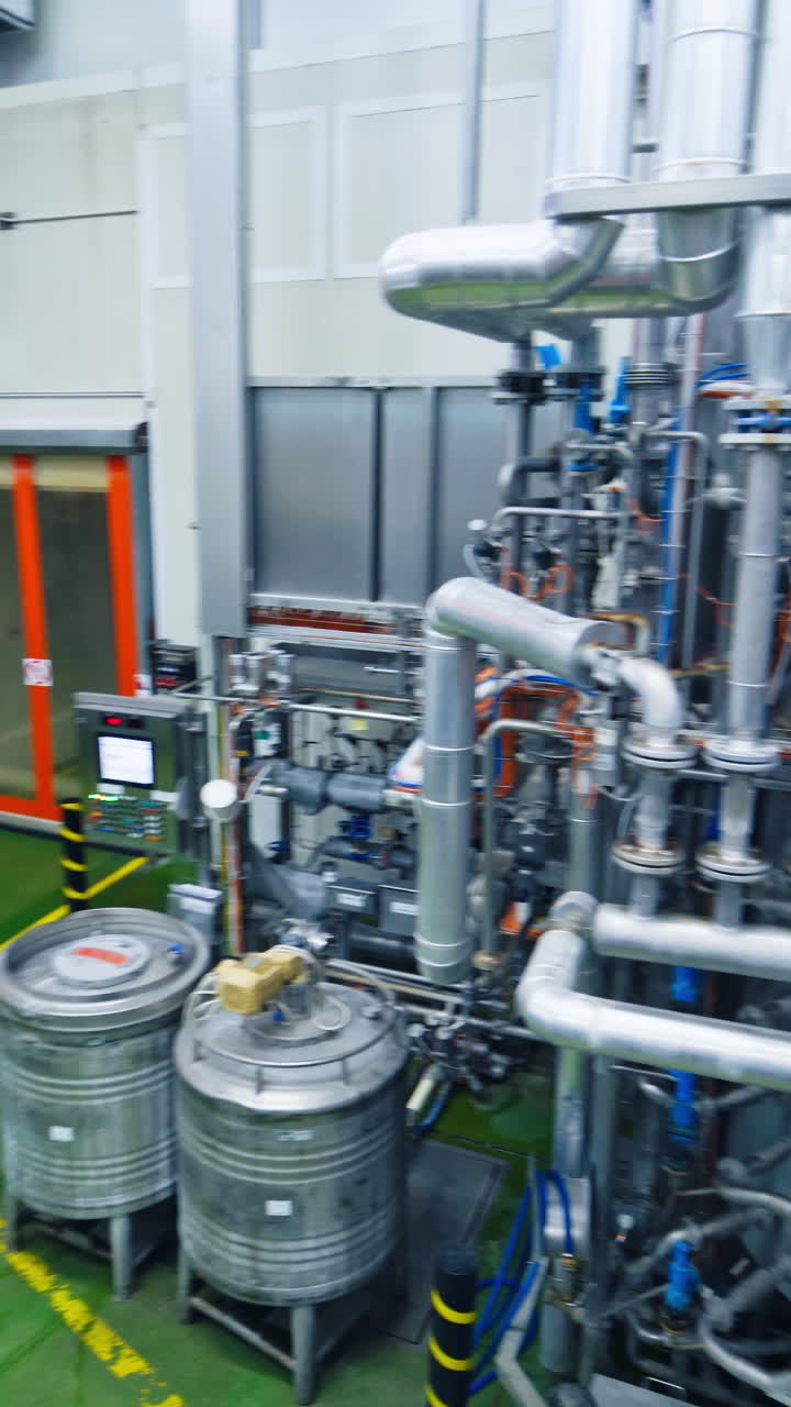 Equipment at dairy plant. Automated technological equipment in modern dairy factory. Vertical video