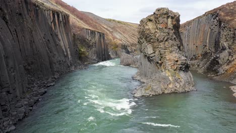 flying through basalt columns in studlagil canyon in east iceland