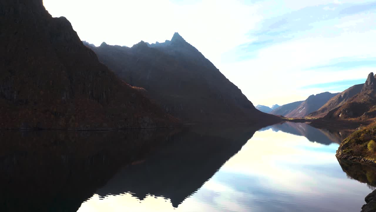 Aerial view of a mirroring fjord and towering mountains of Lofoten, fall in Norway