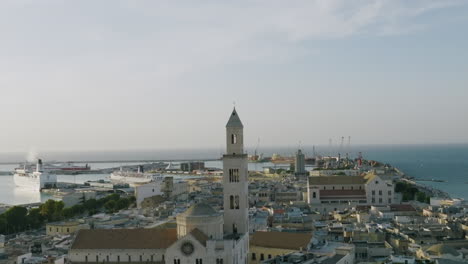 aerial footage rotating around the the church spire on the basilica cattedrale metropolitana primaziale san sabino in bari, italy during sunset