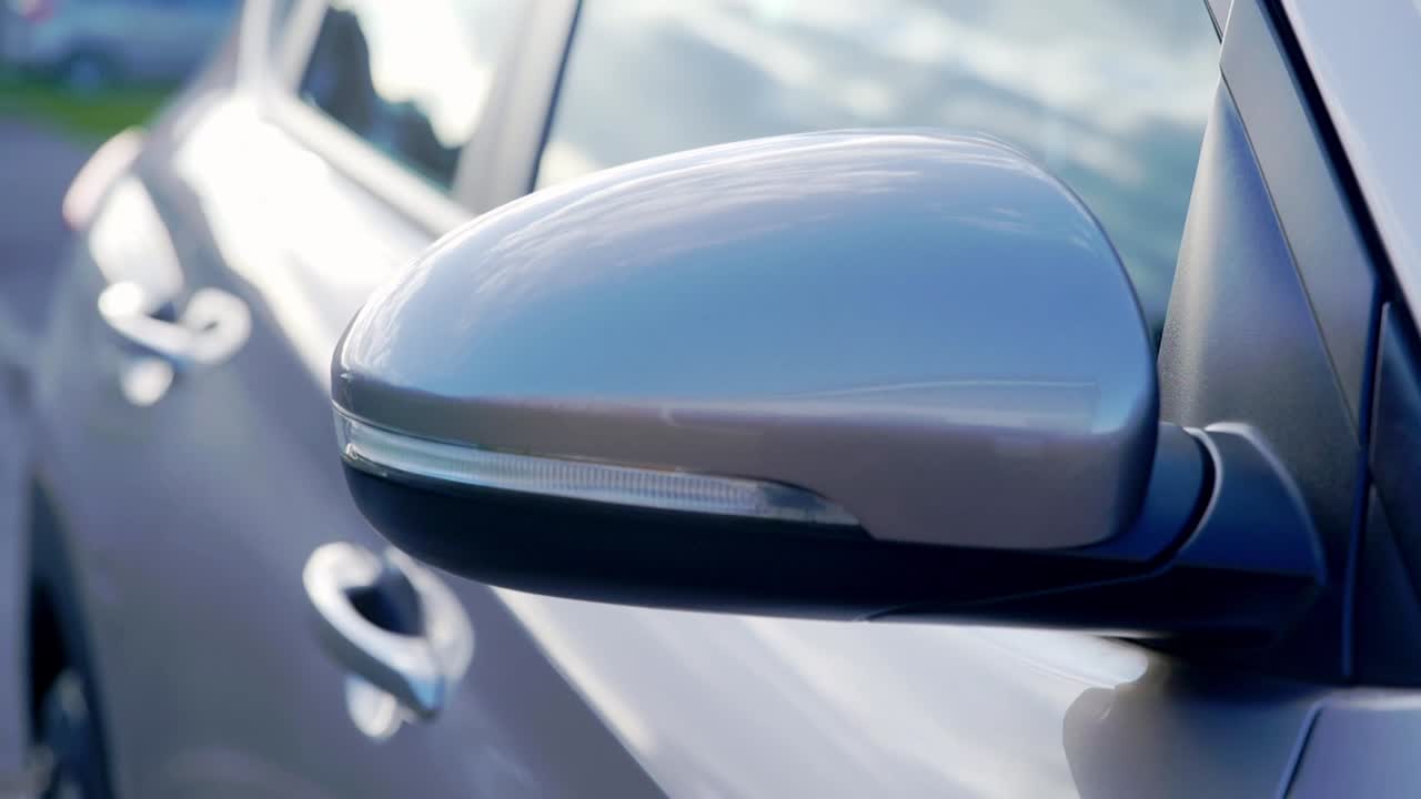 Close up orbiting shot of grey SUV mirror