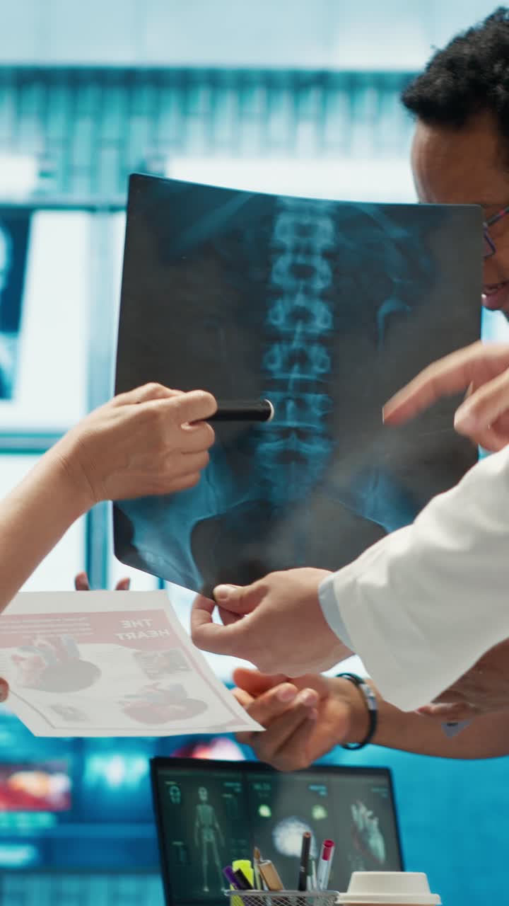Vertical Video Doctors analyze human anatomy scans in a treatment center