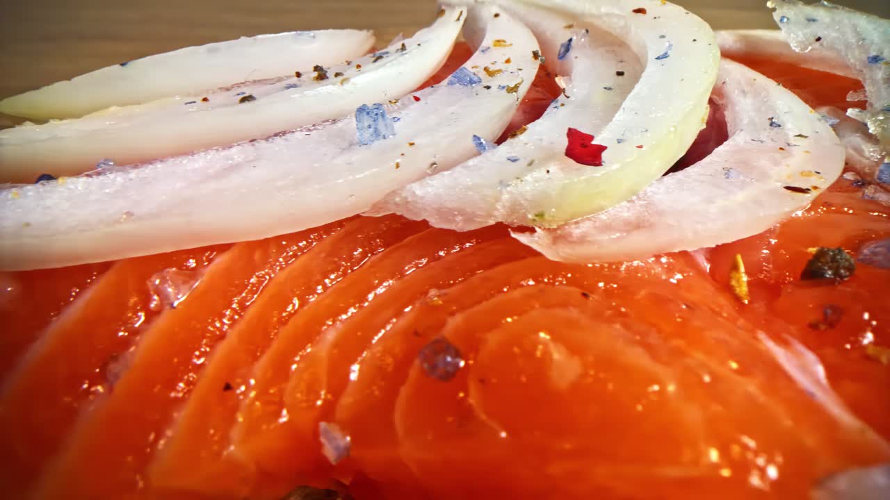 Close-up of fresh sliced tomatoes, onions, and spices on a wooden table