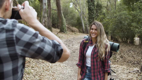 Happy-tourist-girl-posing-for-photo-camera