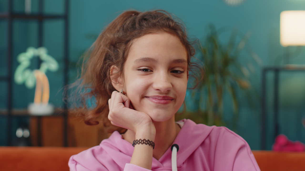 Portrait of happy school girl smiling friendly glad expression looking at camera relax good news