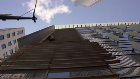 a window washer works on a sunny day