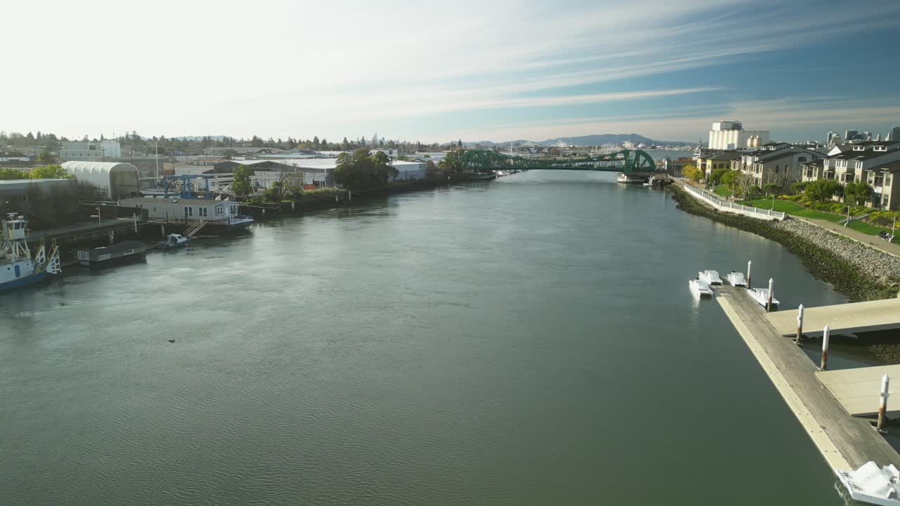 A drone glides above the Tidal Canal, highlighting the green steel structure of the Park Street Bridge.