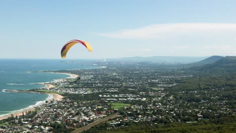 paraglider flying over beautiful vast cityscape on sunny day