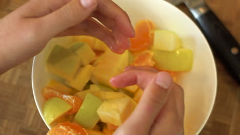 Close-Up-of-Female-Hands-Mixing-Bowl-of-Salad