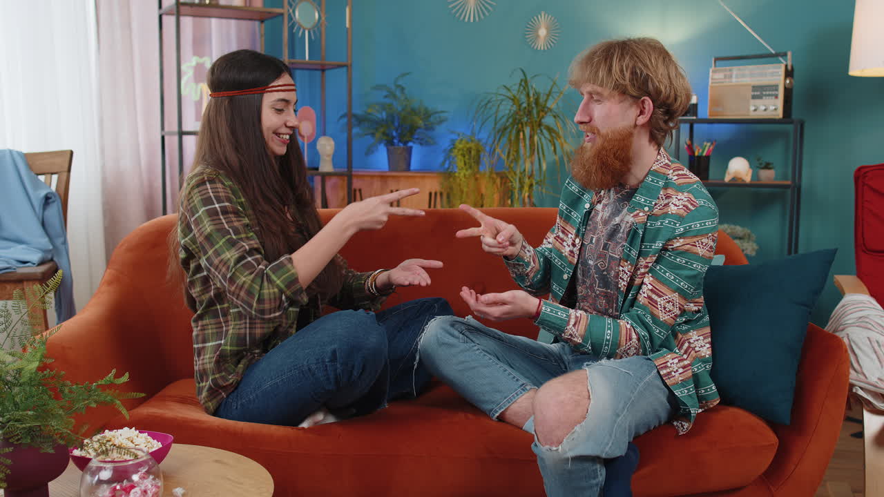 Family marriage hippie couple man woman laughing playing to rock paper scissors gambling hands game