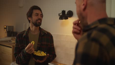 friends enjoying snacks in the kitchen