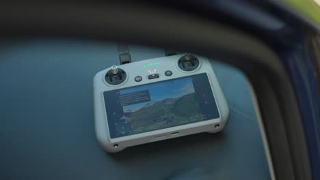 드론 뷰를 보여주는 모니터와 함께 dji rc 원격 드론 컨트롤러의 근접 촬영