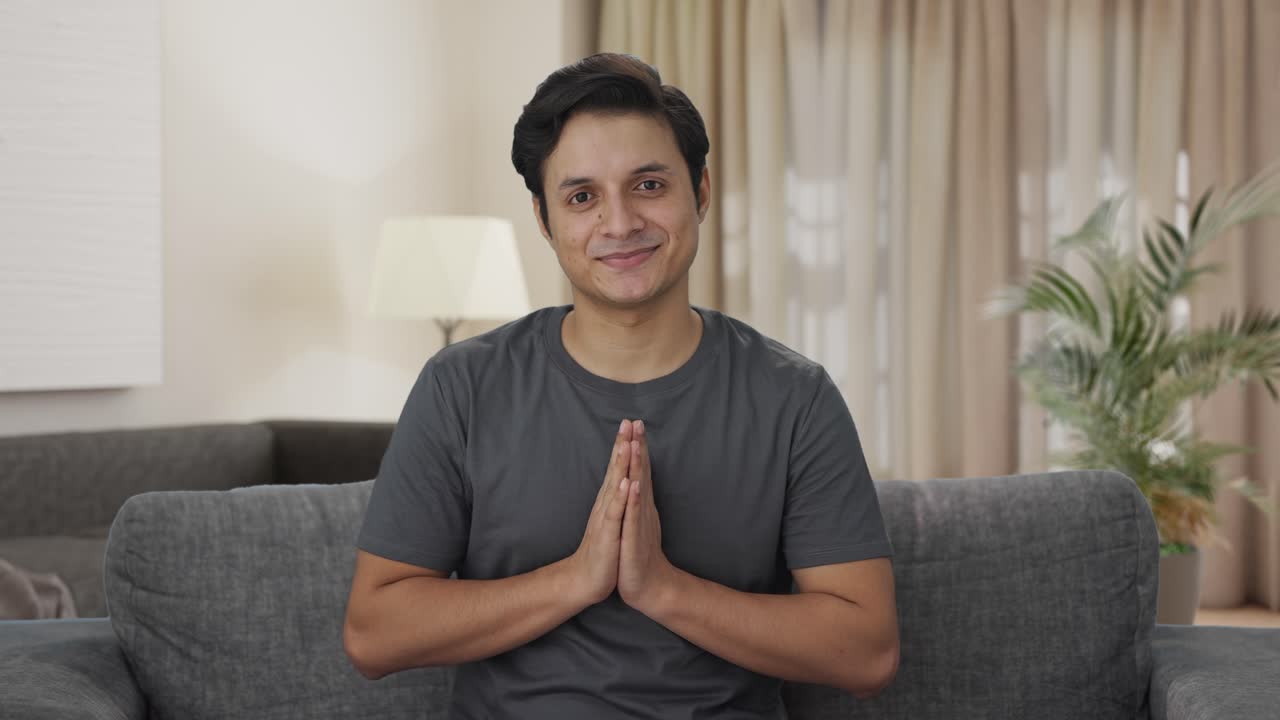 Happy Indian man doing Namaste
