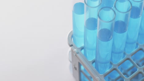 vídeo de tubos de ensayo de laboratorio de vidrio con líquido azul con espacio de copia sobre fondo blanco