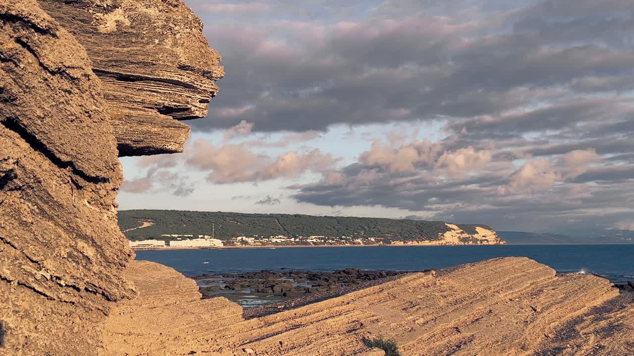 Majestic time-lapse video of rocky formation on the beach, sea waves are crashing to the coastline