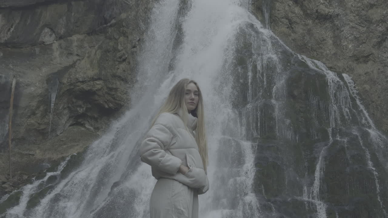 Woman in front of a Waterfall
