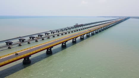 aerial drone shot of rameshwaram city with a sweeping view of the iconic bridge stretching across the sea.