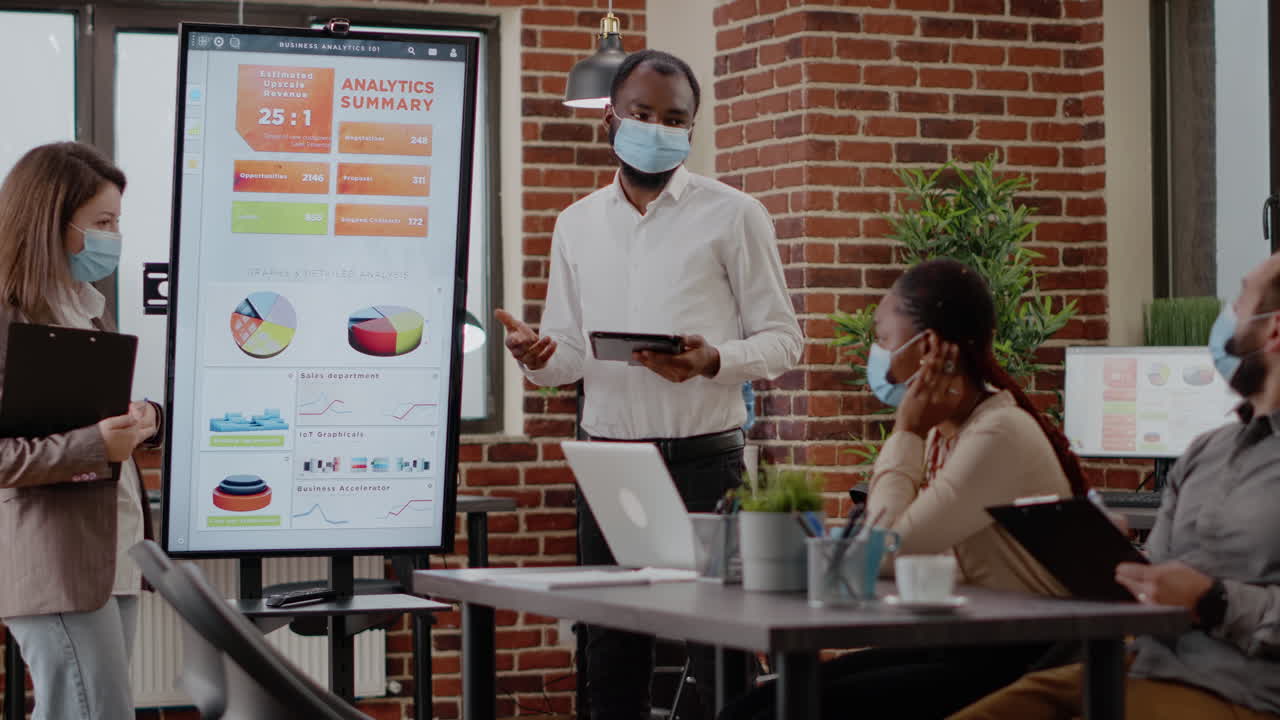 Team of diverse workmates presenting business strategy on display
